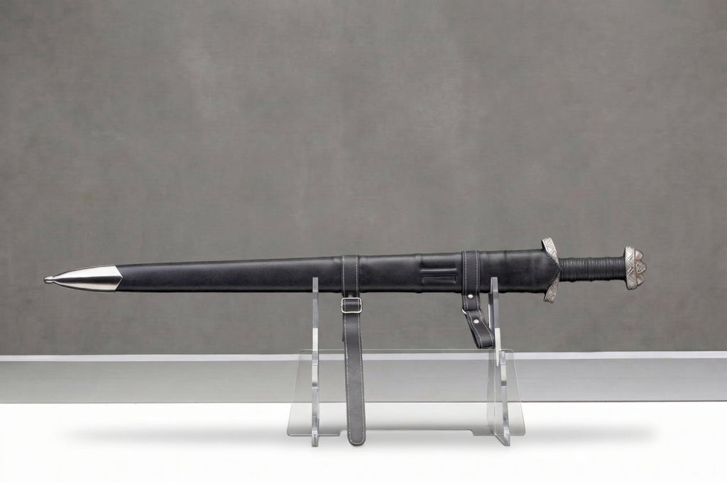 Blackfjord Viking Sword: Black leather viking sword in scabbard with silver fittings, white stitching, on clear stand, grey background