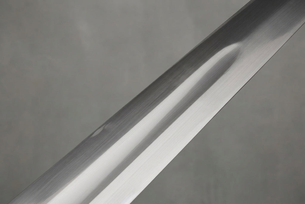 Goldwarden Arming Sword: Polished silver sword blade with a central fuller against a light grey background