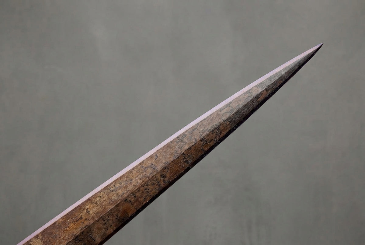 Morgul-Blade of the Witch-king - Lord of the Rings Sword: Dark, textured sword blade tip with sharp, light edges against a smooth grey background