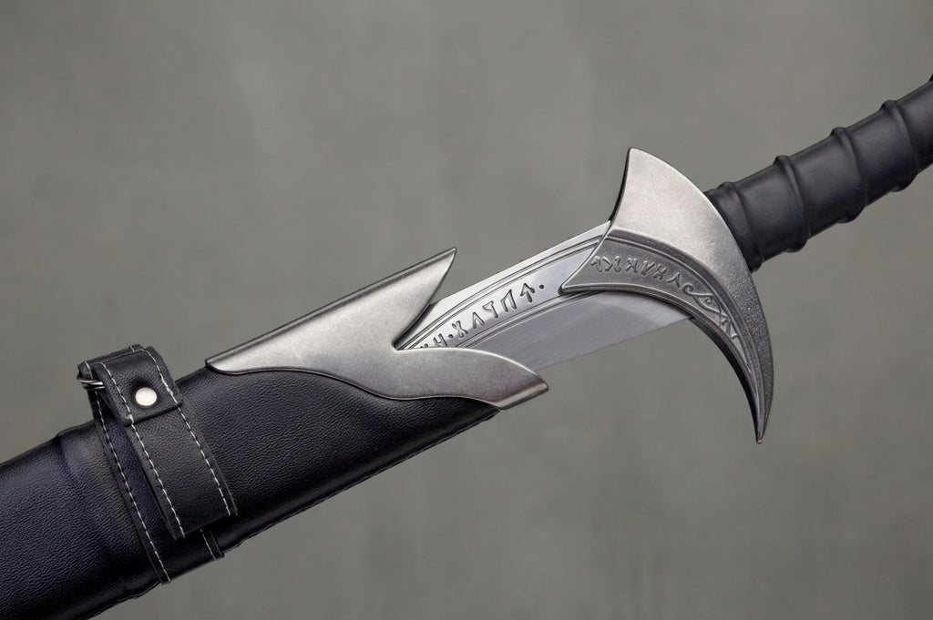 Orcrist Sword - The Hobbit: Partially sheathed silver sword with engraved guard and blade, black leather scabbard and grip, on grey background