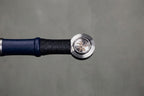 Sapphire Guard Longsword: round silver pommel with engraved emblem black wrapped grip and navy blue leather on grey concrete background