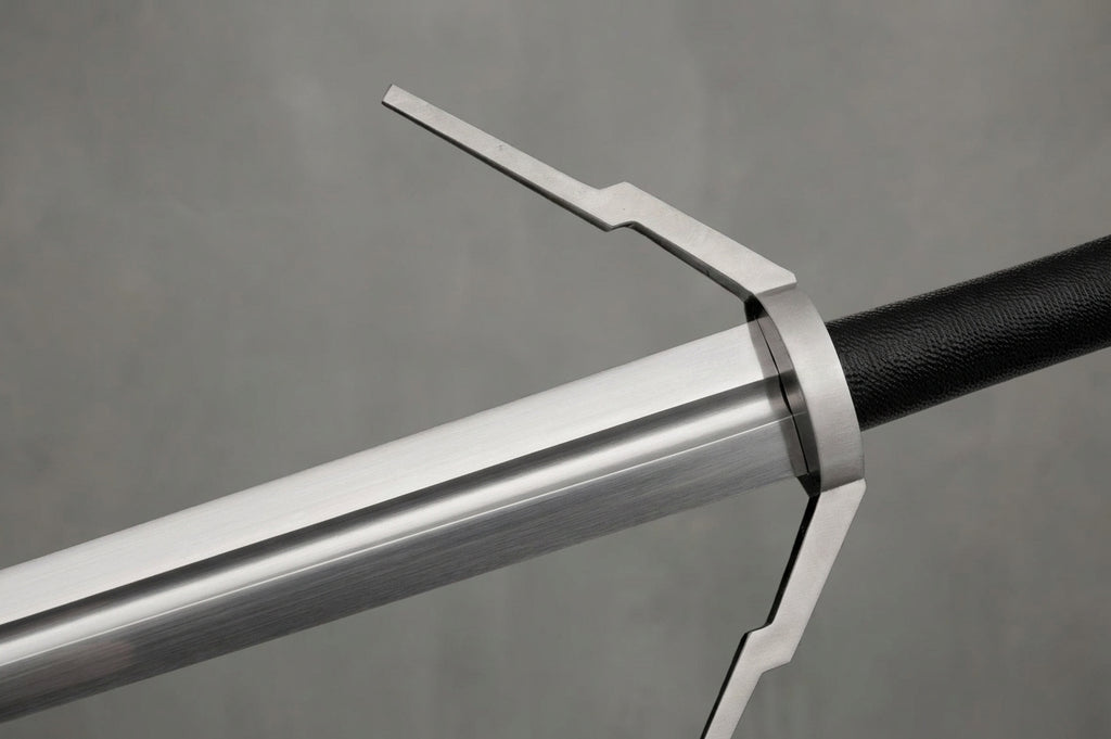 Wolf School Longsword - The Witcher 3 Inspired: Silver metal longsword blade and angular guard with black leather grip on grey background
